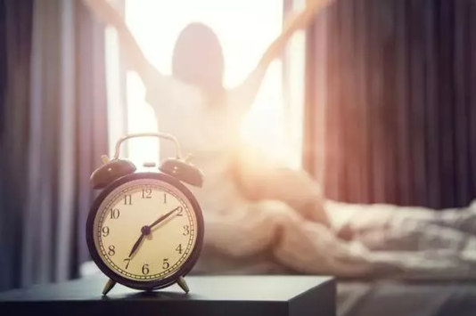 Person waking up with morning sunlight